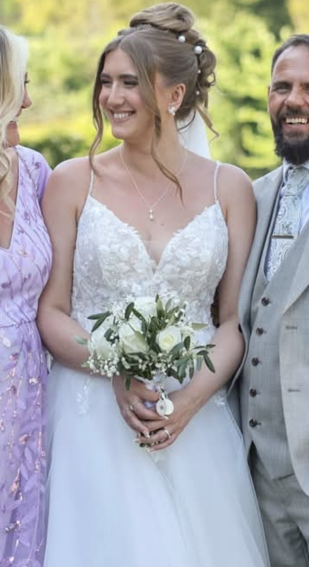 Bride with a white rose and gypsophila bouquet