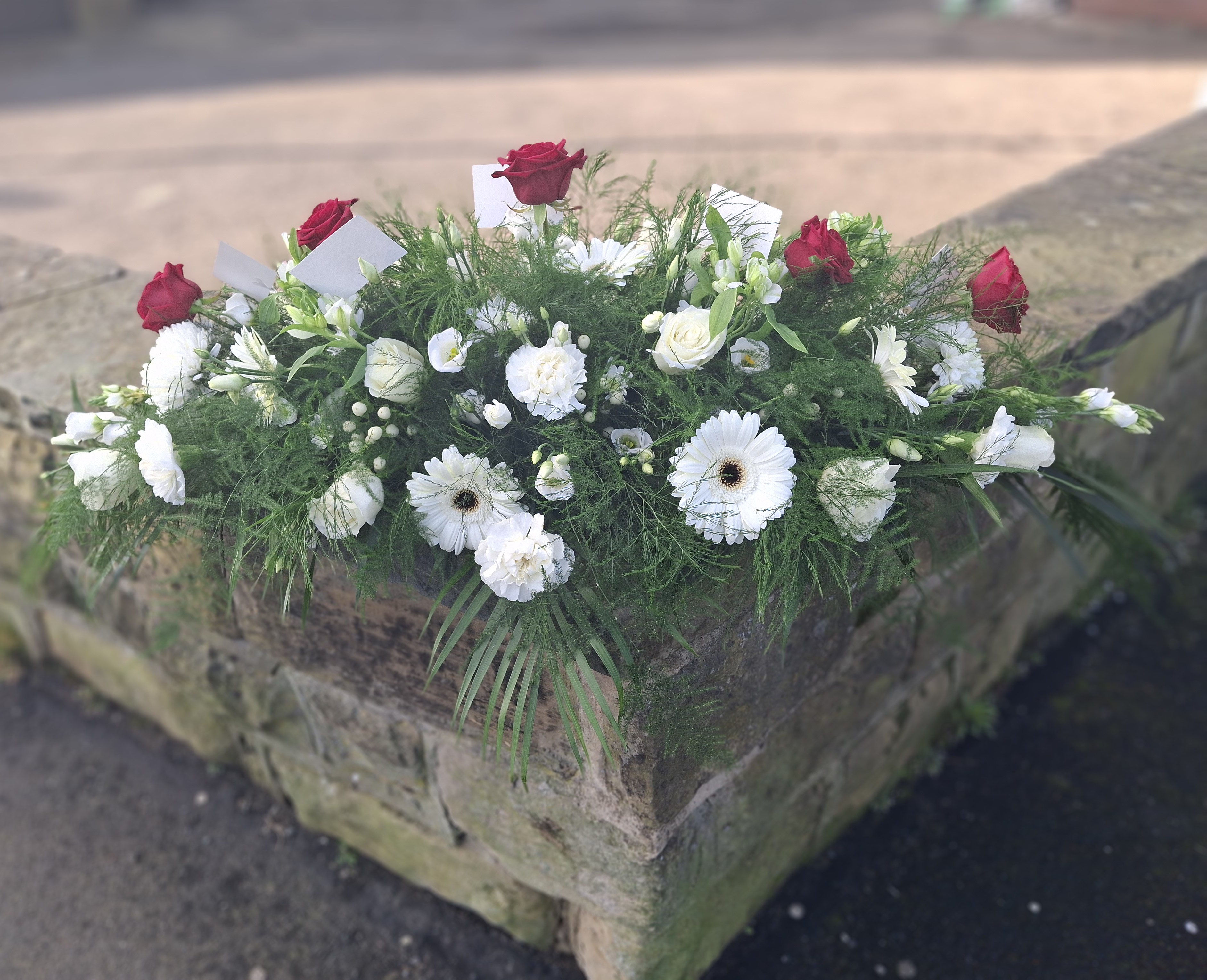 White and red rose casket spray